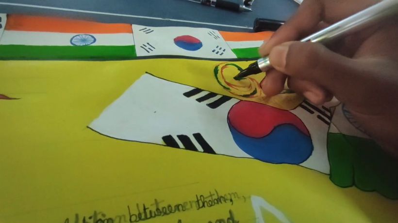 A hand painting flags of India and South Korea