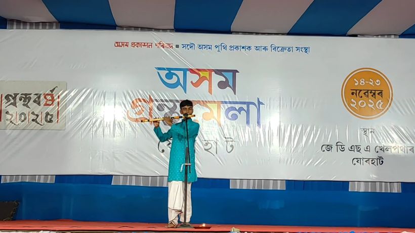 A student playing flute on stage
