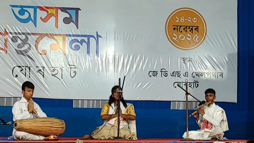 Three students playing khol, flute and singing