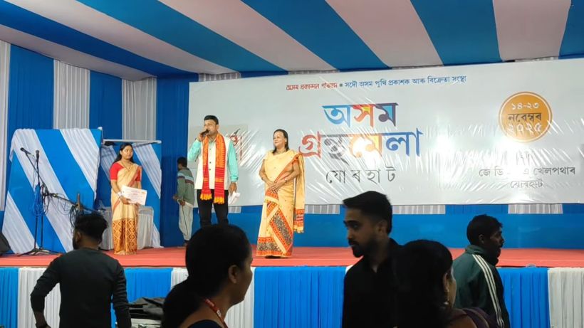 Three hosts in gamosa and mekhela on the book fair stage