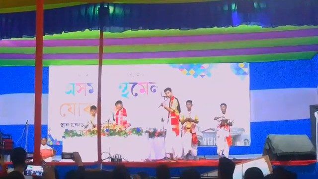 Students performing on a colourful stage