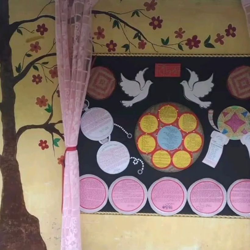 A painted mural of birds and flowers on a school wall